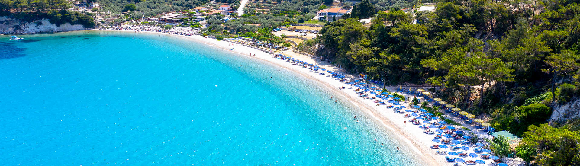 Traumhafter Tsamadou Beach auf Samos mit kristallklarem Wasser und Pinienwald im Hintergrund