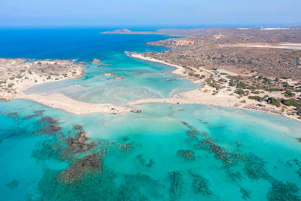 Luftaufnahme vom Elafonissi Strand auf Kreta mit rosa Sand und türkisfarbenem Wasser